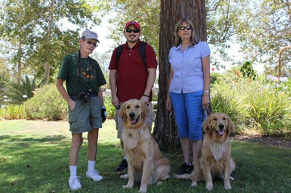 Apache with his puppy raisers