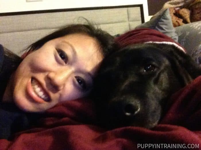 Mommy, Ali, and Black Lab Stetson lying on the bed